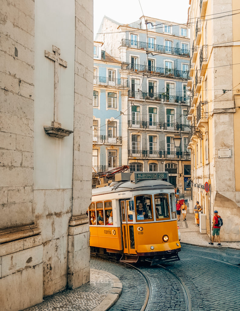 Tram 28 emerging from around the corner in Lisbon